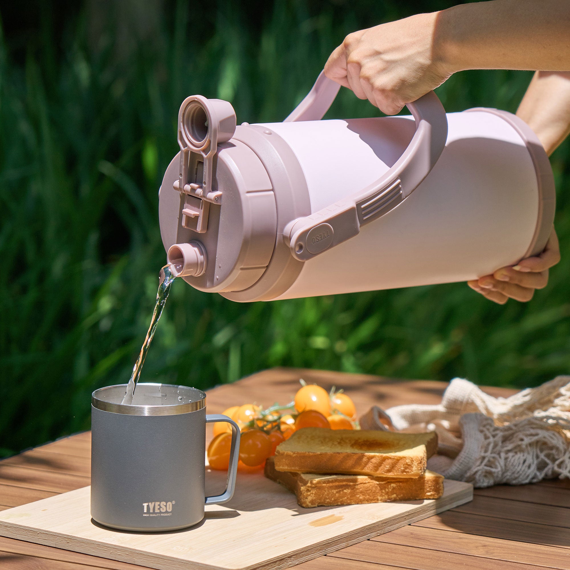 TYESO STOCK pink sports bottle pouring water outdoors #color_pink