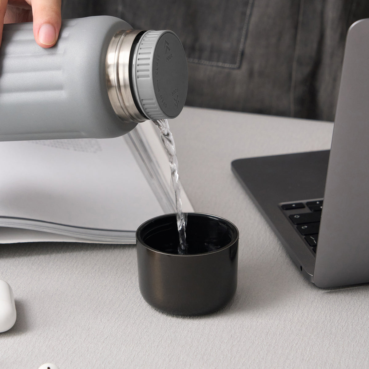 FLUTE bottle twist stopper pouring into the cup lid at a desk  #color_gray