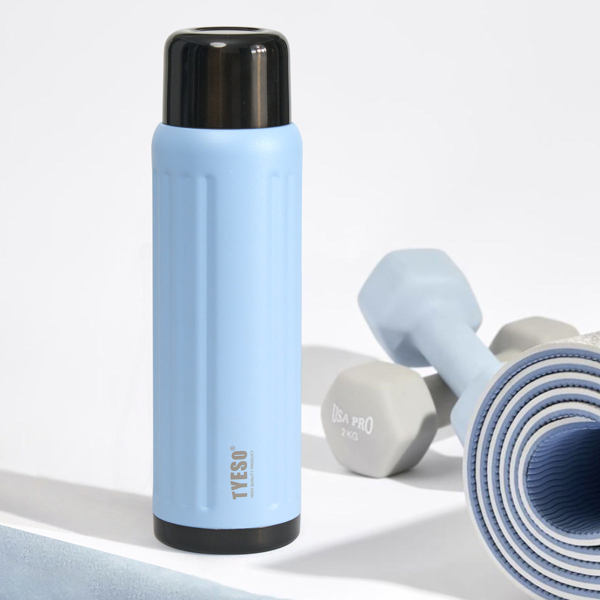 Sky Blue FLUTE insulated bottle beside workout equipment #color_sky blue